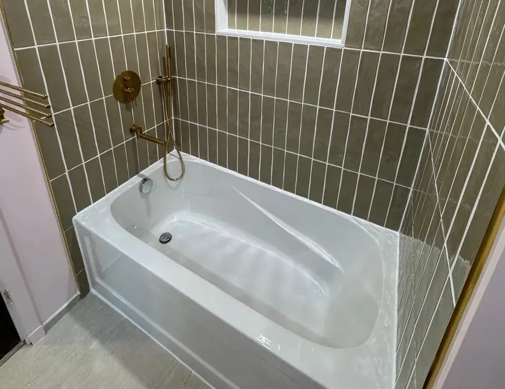 New alcove bathtub with vertical green wall tile after a tub-to-tub conversion