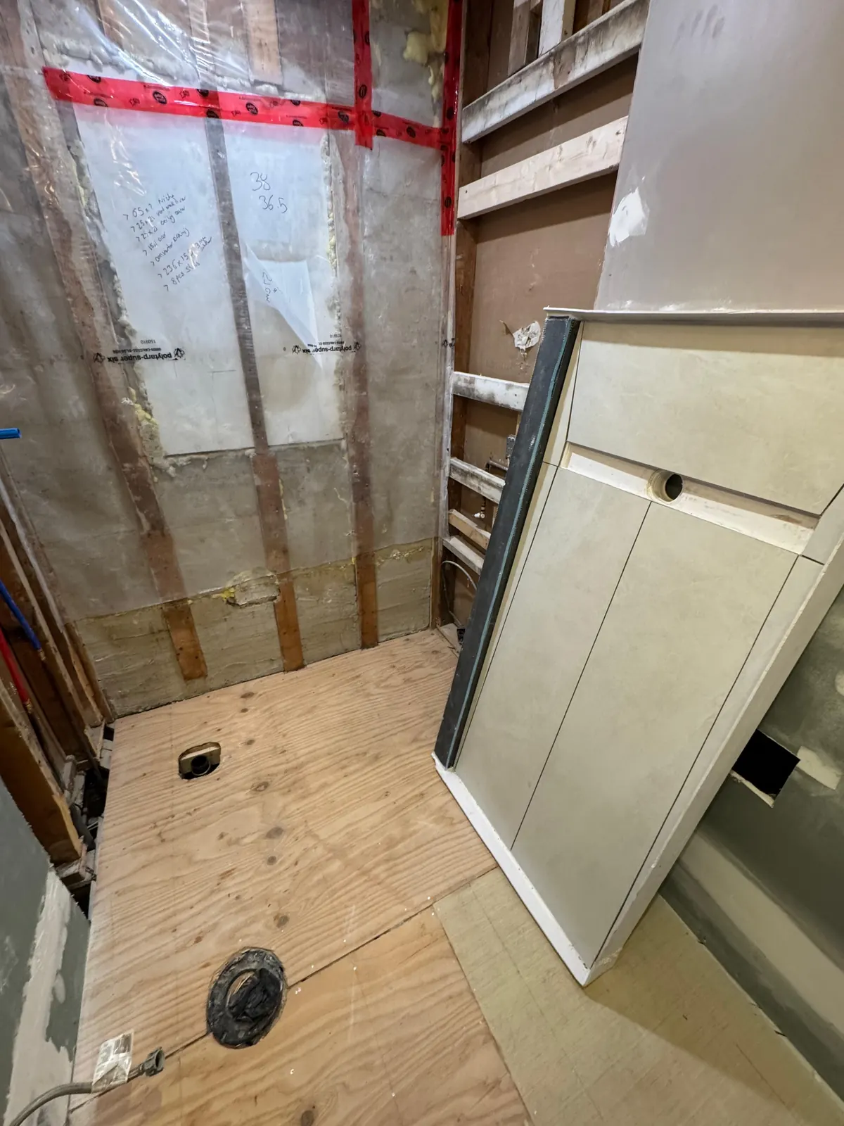 Install day: a Canzeno shower base going into a bathroom stripped to the studs