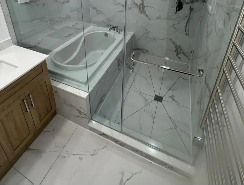 Bathroom renovation with a glass shower beside the tub
